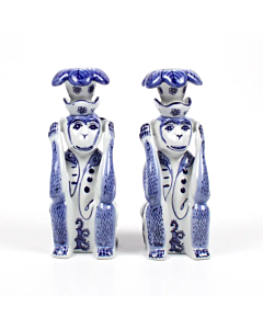 BLUE AND WHITE PAIR OF MONKEY CANDLESTICKS